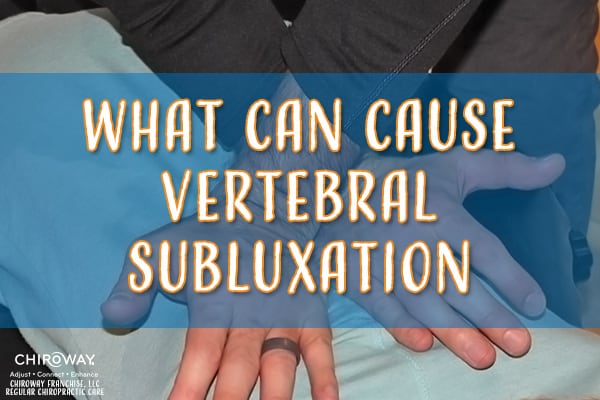 What can cause vertebral subluxation? Photo of a chiropractor making a thoracic adjustment.